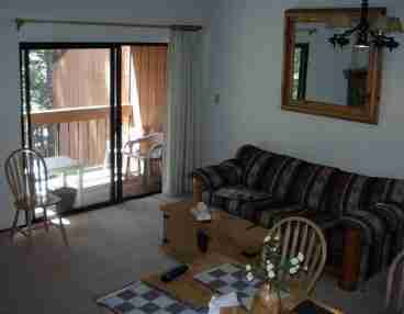Living room, couch, & balcony deck.