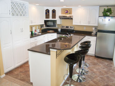Newly remodeled kitchen - Stainless steel appliances, granite counter tops, dishwasher and microwave.  Convenient snack bar on island.