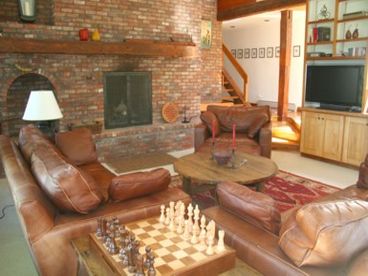 The living room has a great wood burning fireplace, access to the outdoor hot tub, mountain views and satellite TV