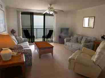 View of the living room.  Notice the ocean visable directly through the sliders!