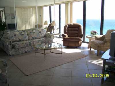 Living Room in two bedroom condo.  Floor-to-ceiling windows facing the ocean.