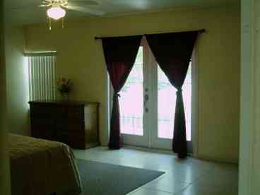 Master Bedroom, with King size bed with balcony looking out to the lake