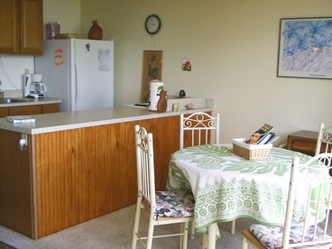 The kitchen/ dining area is open to the living room (you can email us and request a  floorplan!). Full stove/ oven, fridge, microwave, blender, coffeemaker , toaster, cookware, and even child friendly plastic dining ware provided. High chair available on request.