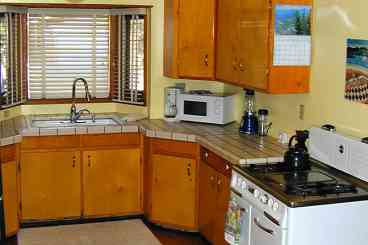 Kitchen is well stocked with Microwave, dishwasher, garbage disposal, full refrigerator, coffee pot and grinder, service for eight, and a great old gas range from the 50\'s.