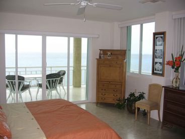 Master Bedroom offers panoramic views of the Carribean Sea  and features large bathroom with marble counter top.