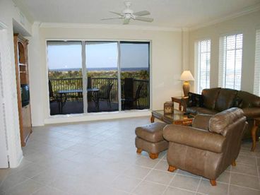 Living room features a leather couch and love seat, TV and DVD player.