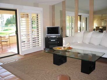 Living room with view onto golf course and San Jancinto mountains.