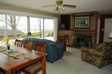 The upstairs living room/dining room opens out on the deck. This area has been set up to be a smaller, intimate area. The main dining table shares this room and seats eight. No Hide-a-beds in this room.