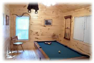 Pool Table in game room overlooking full length back deck with woodland views.