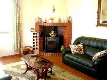 Comfortable living room with feature fireplace.