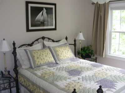 A queen bed with matching nightstands and bench grace the upstairs bedroom. Provacy and quiet comes from two doors between the bedroom and loft.