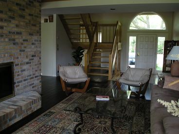 Living room shares cathedral ceilings, see-through fireplace with formal dining room.  New hardwood floors.  Large windows overlooking golf course.