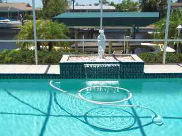 outdoor heated screened pool & waterfall/patio area
