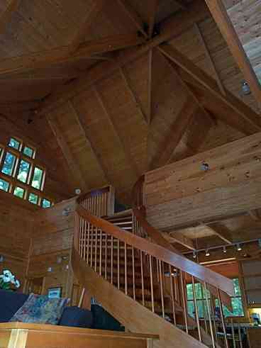 The curved mahogany staircase is a prominent feature of our 30 foot tall great room.