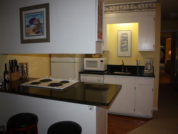 Fully equipped kitchen.  New granite counters, and new flooring in kitchen area. 