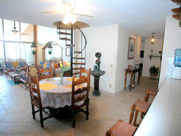 Sweep of Main Areas: Dining Room (foreground) Living Room & Beachfront Terrace (back left), Hall to Bedrooms (back right), kitchen (right-out of photo)