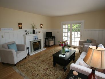 Flat screen TV, fireplace, lots of windows and light
