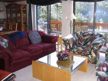 Living room with a view of the deck and beyond