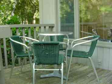 Back Deck with photos and Chairs overlooking quiet lagoon.
