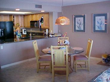 Granite counter-tops, maple cabinetry, and tile floors compliment this area.