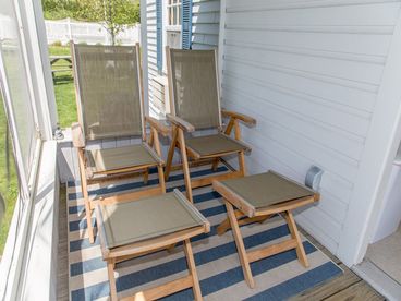 Screened side porch on Cottage 3. A quiet space to relax enjoy a peek at the distant ocean views.