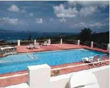 Outdoor pool sets on top of the hill overlooking scenic Cruz Bay