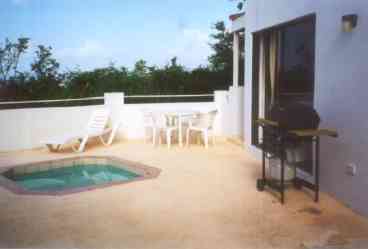 Private patio with mini pool and BBQ is nestled between master bedroom building on left and the main condo area on right. 
