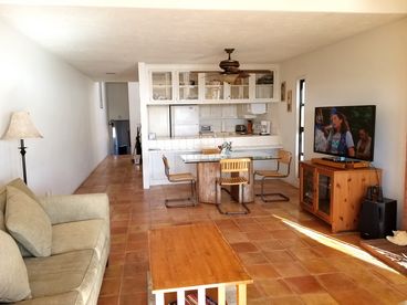 The hall leads to the 2nd Queen size bedroom, bathroom and laundry room. Here is the kitchen, cable tv, sofa and love seat to relax and watch over the ocean