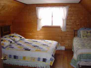 Tastefully decorated with a country mountain feel. This bedroom has a queen and twin bed.