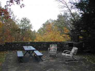 Bluestone patio with grill and cooling shady oaks.