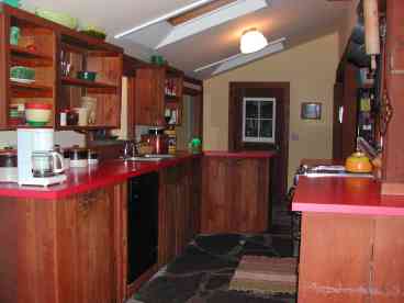 Well-equipped kitchen with woodstove and island counter