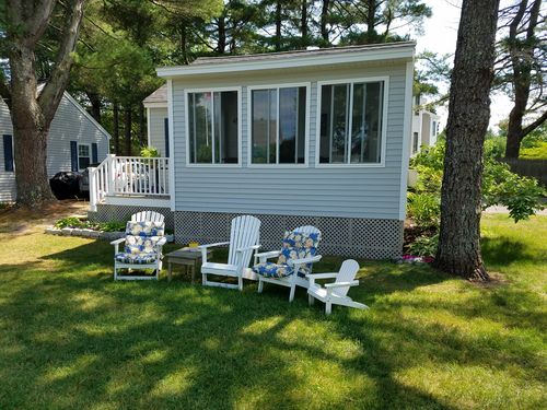 3-season porch on Cottage 6 overlooking the lawn and pool area