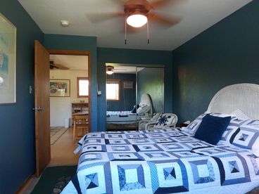 The air-conditioned bedroom has a queen bed, tv & a ceiling fan.