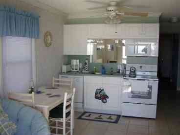 Well stocked kitchen, with dishwasher, radiant range, ref. with water purifier and ice maker.  View from kitchen table of the ocean.