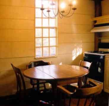 Large old fashioned eat-in kitchen with original wood panels.