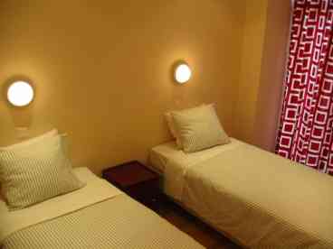 Cozy bedroom with a balcony to the street, and good, firm mattresses on the beds