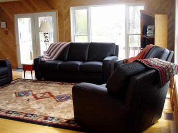 Beautiful & comfy leather furniture in living room with wood burning fireplace! 