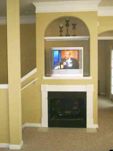 Arched Entertainment Center above Gas Fireplace in great room.