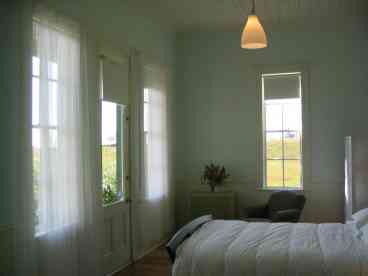 The master bedroom with private deck has a spacious en suite bathroom with bathtub and shower.