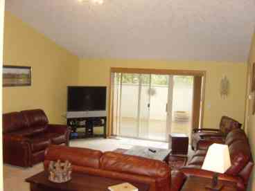 Spacious Great Room with big screen TV and comfortable leather furniture.