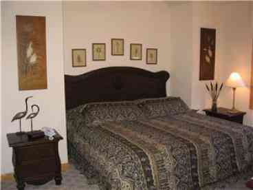 Exquisitely decorated King Master Bedroom with Color TV - VCR.  Adjoining spearate bath has Jacuzzi Tub, separate shower, and his & her vanities.