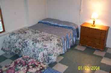 Bedroom on water level of  home has two double beds.