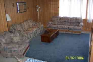 Living room overlooks the pond and is open to the dining room.