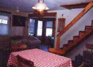 The kitchen is open to the stairway and small nook overlooking the pond.  A great place to watch the loons and fish while playing games or cards.
