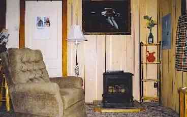 Gas fired wood stove is located in the livingroom.  